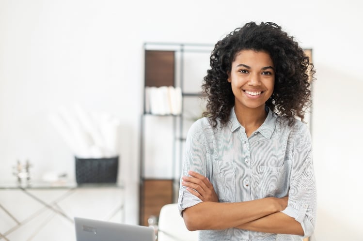 smiling-young-black-woman-standing-in-office